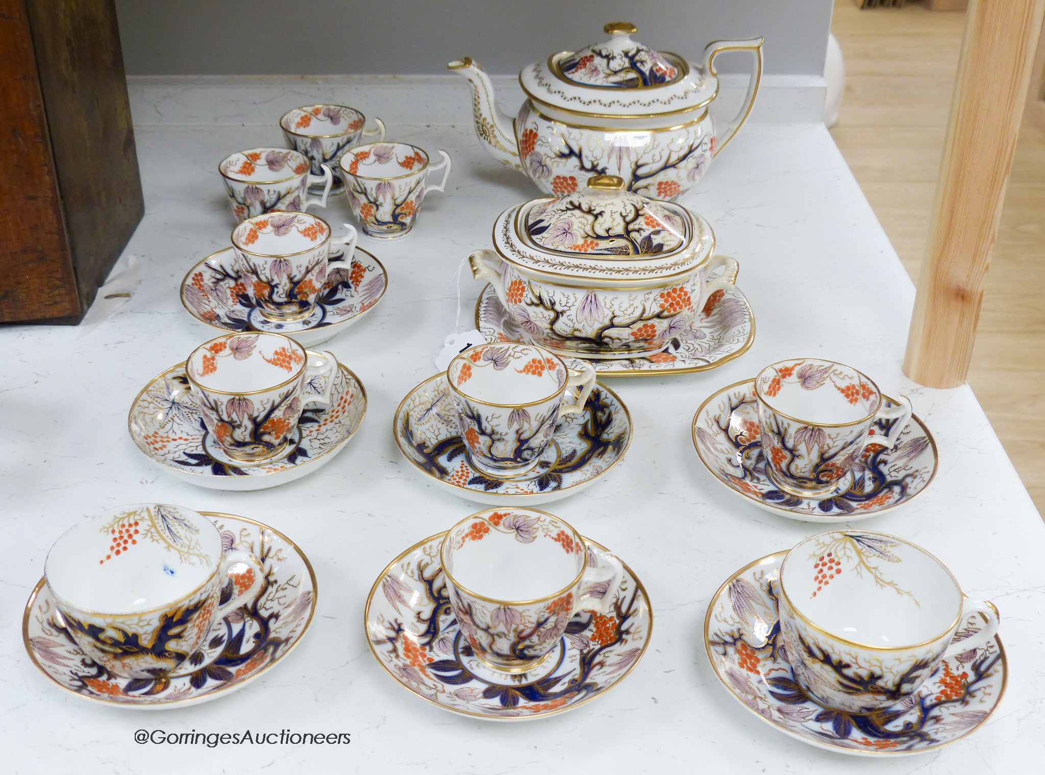 A New Hall part tea and coffee service painted with pattern 446, some pieces marked, consisting of a teapot cover and stand, sucrier and cover, two trios, six coffee cups and five saucers, teapot 16cm high including cove